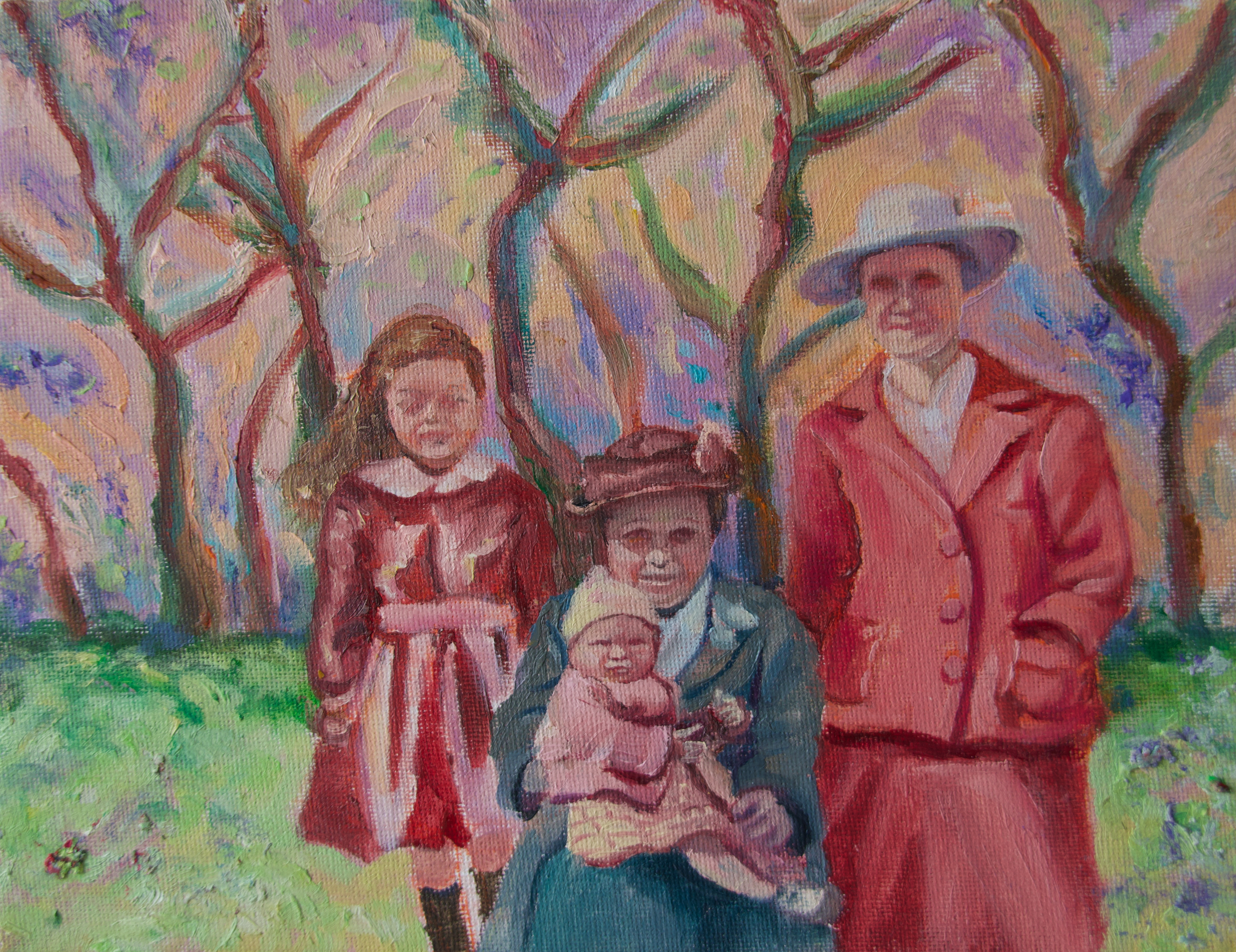 Two women, a little girl, and a baby in front of trees