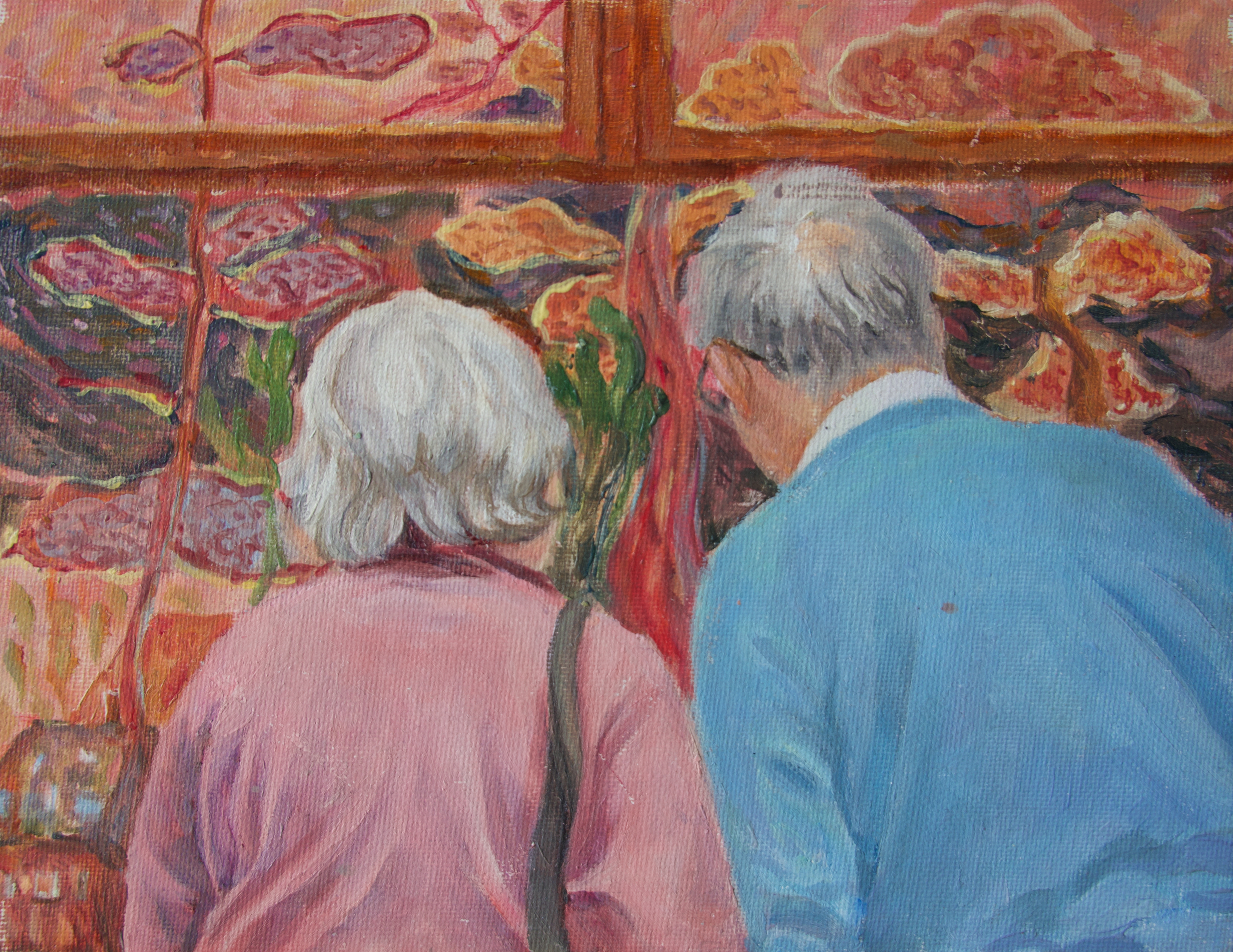 An older couple looking at a painting 