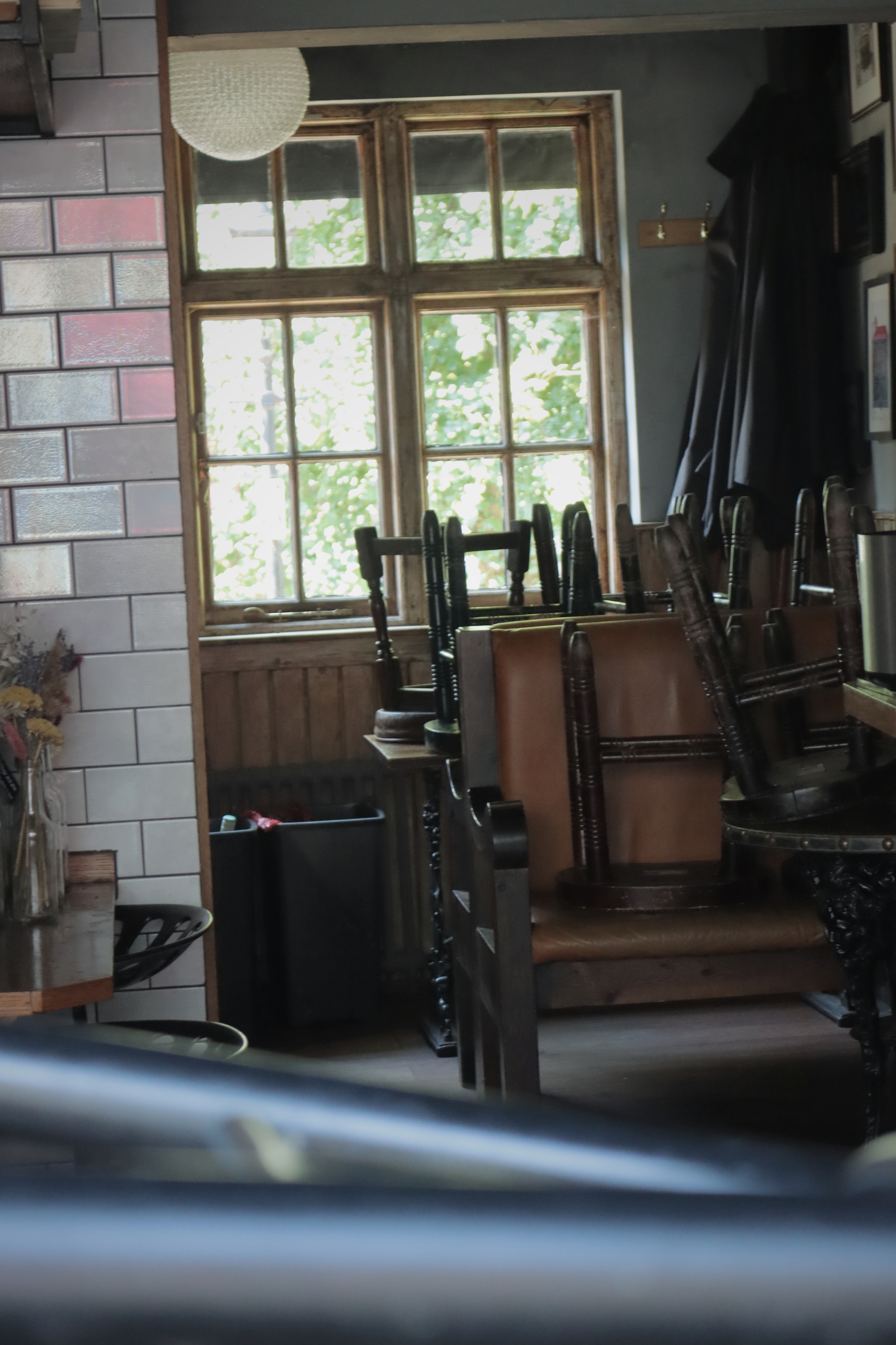 photo of stacked chairs in a pub By Matteo