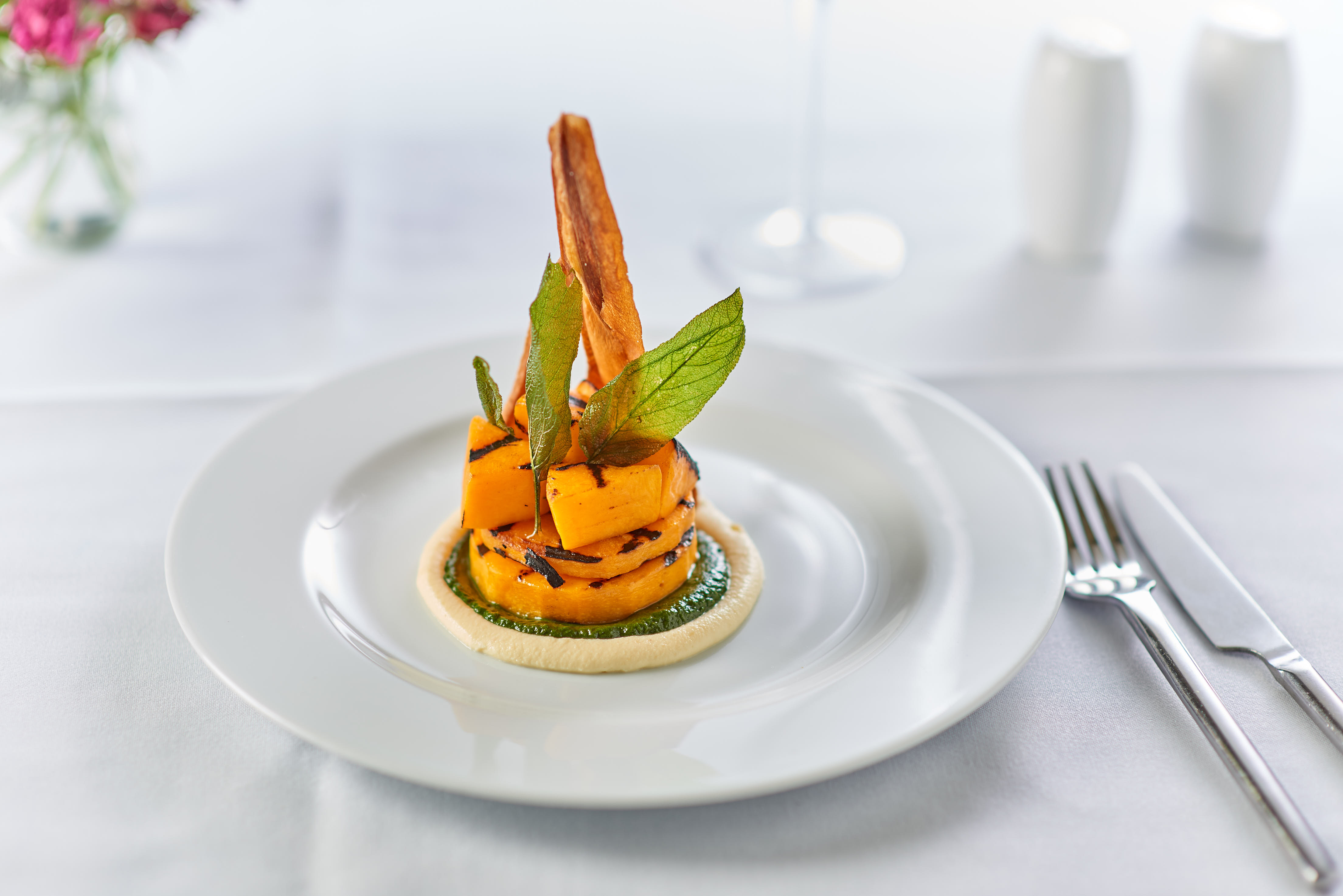 n Pink Food's roasted butternut squash with spinach puree and fontina cheese sauce and garnished with sage and parsnip twill, butternut squash