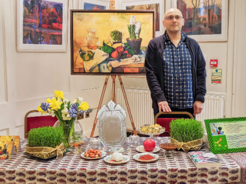 Curator Mehrdad with the Haft-sin display